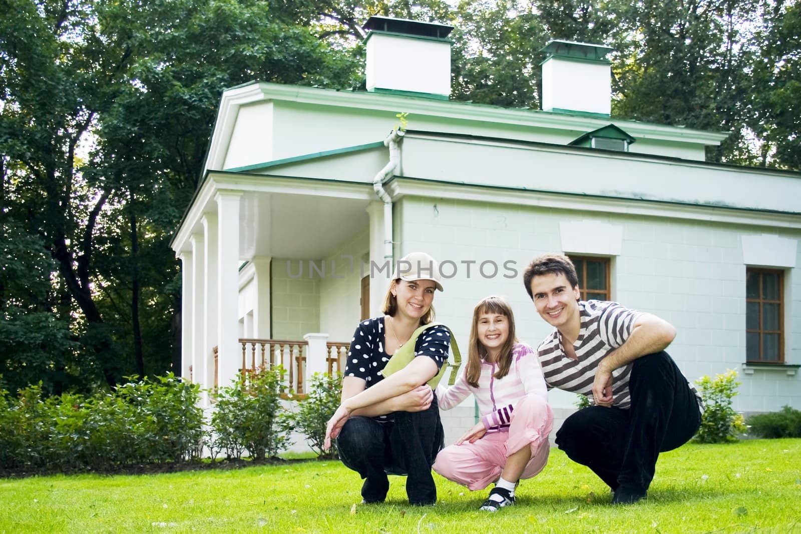 Lucky family on lawn beside its building