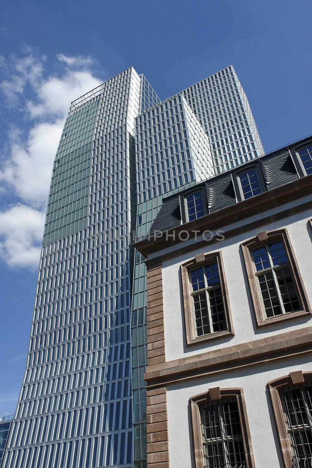 Street view of the rebuild Thurn und Taxis Palais in front of a modern office tower in downtown Frankfurt.