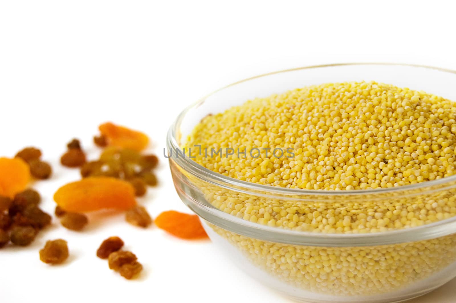 Millet and dried fruits over white
