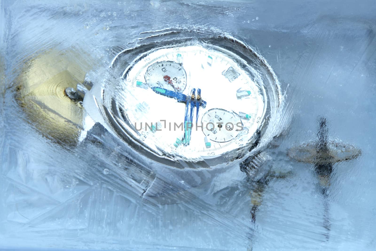 Closeup of wrist watch and gears under frozen water