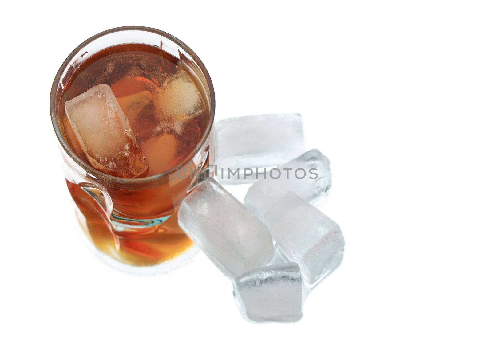 Glass of whiskey with ice cubes on white background with reverberation