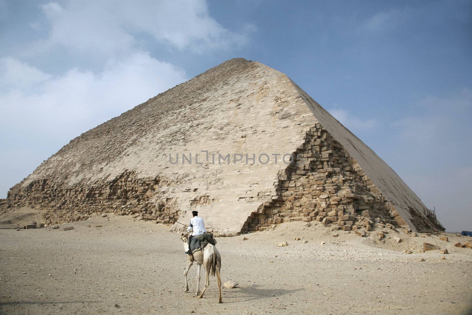 police riding on a camel next dahshur pyramid