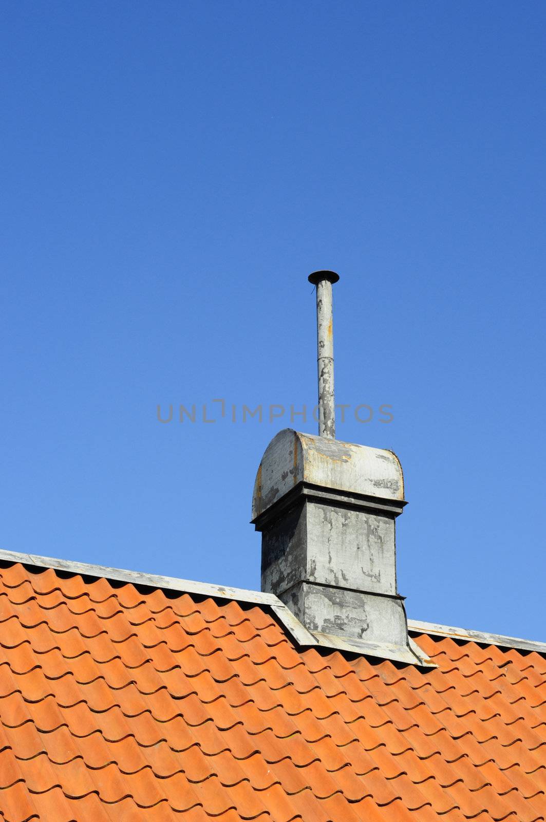 different looking tin chimney on tile roof