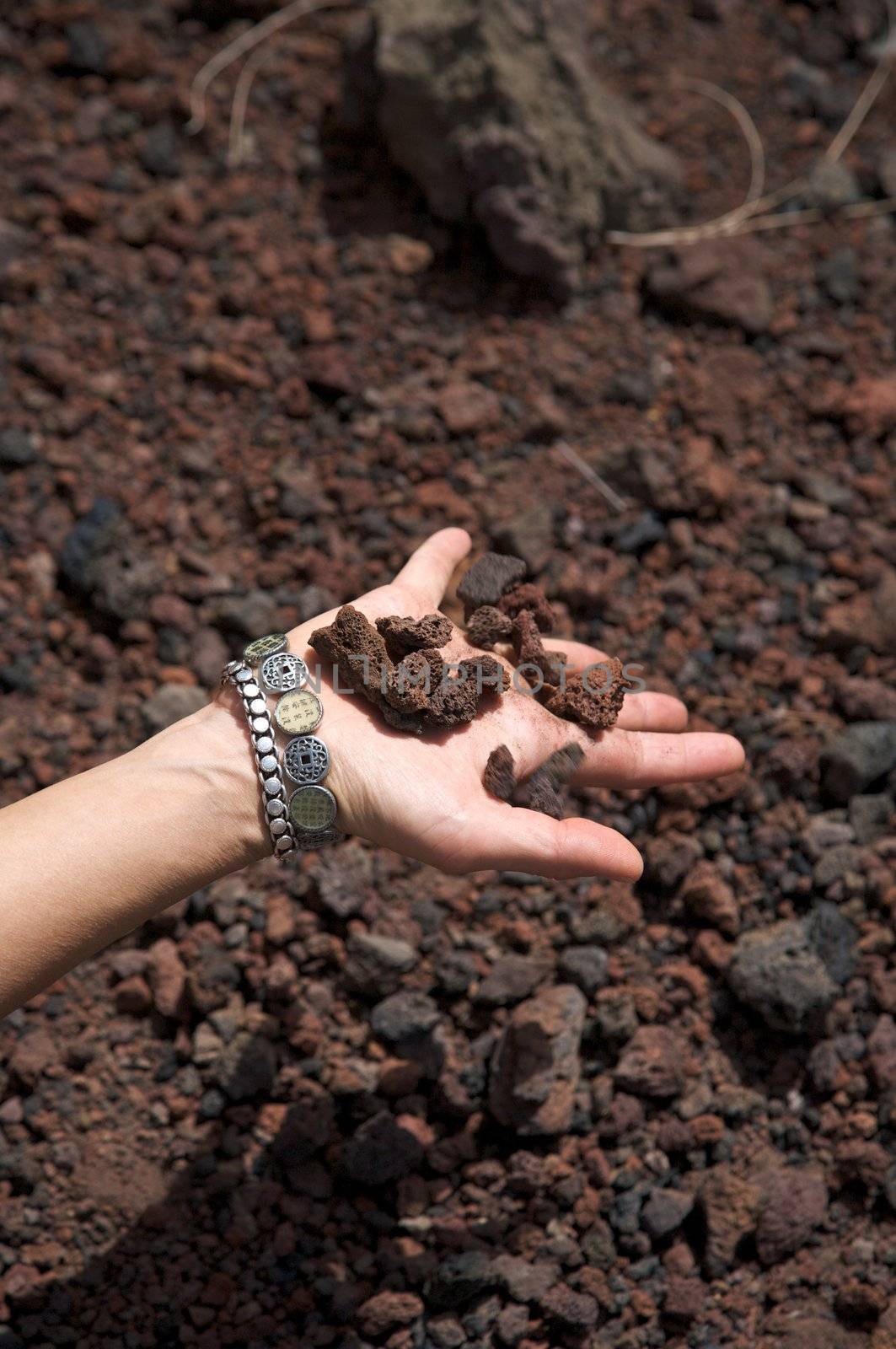 woman hand with volcanic stones