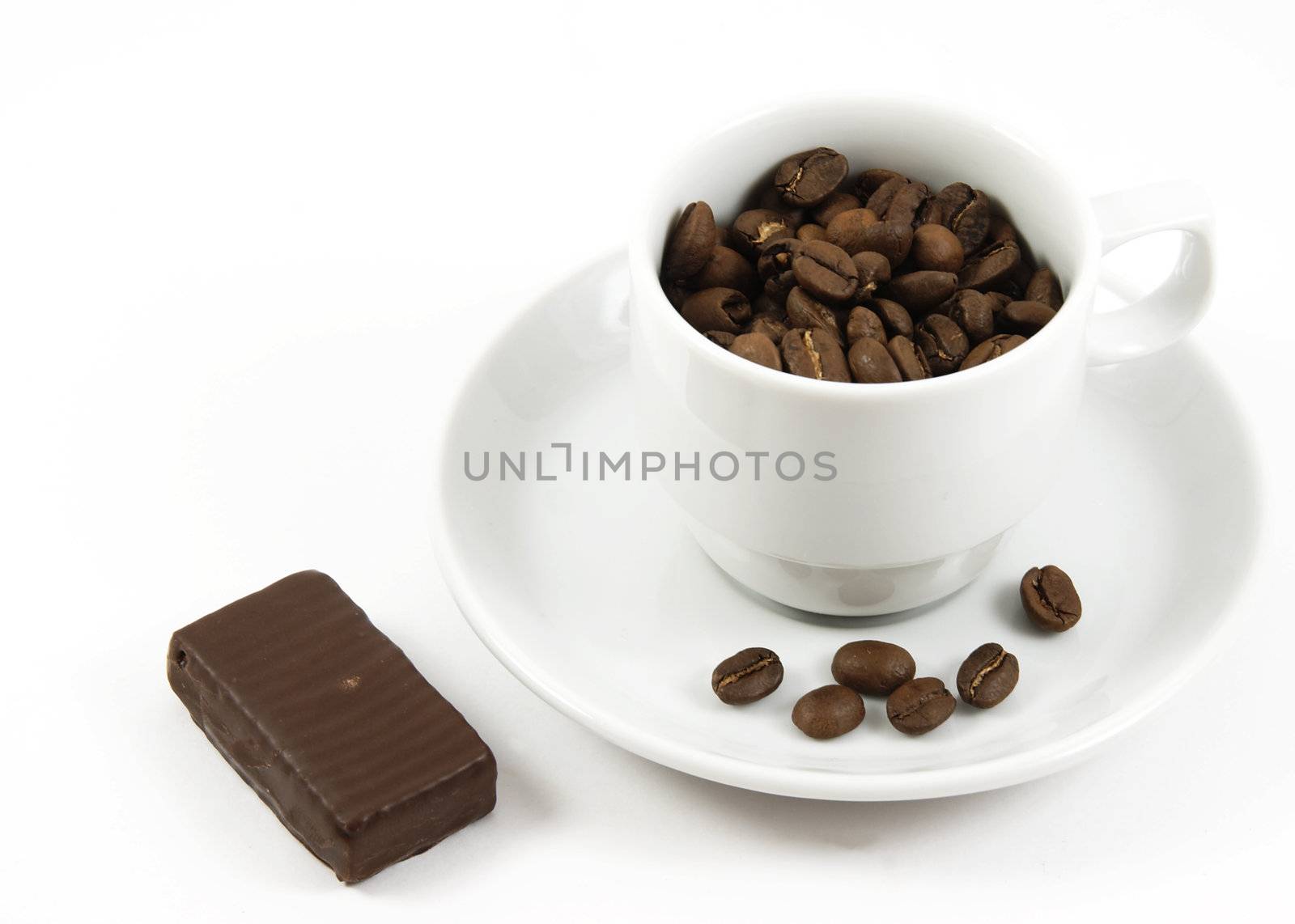 Cup with coffee beans and chocolate isolated by serpl