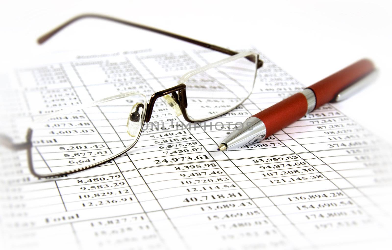 Financial report with pen and glasses by serpl