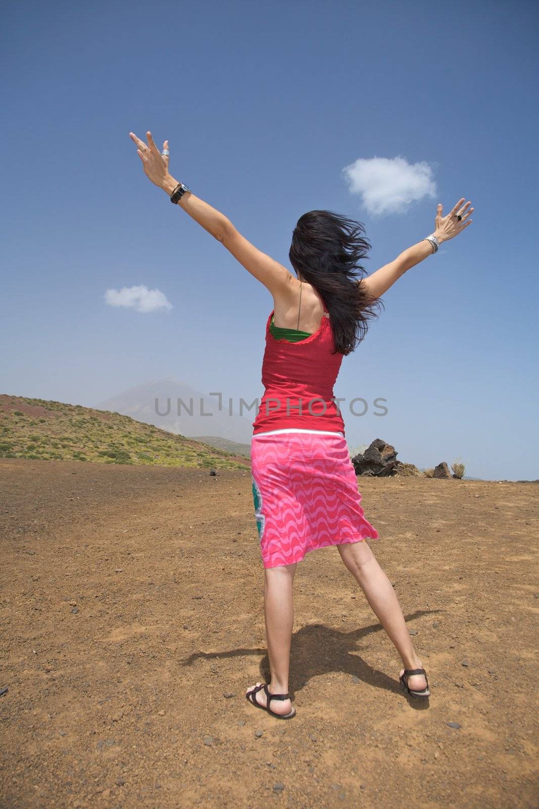 woman open arms with the teide volcano at the background