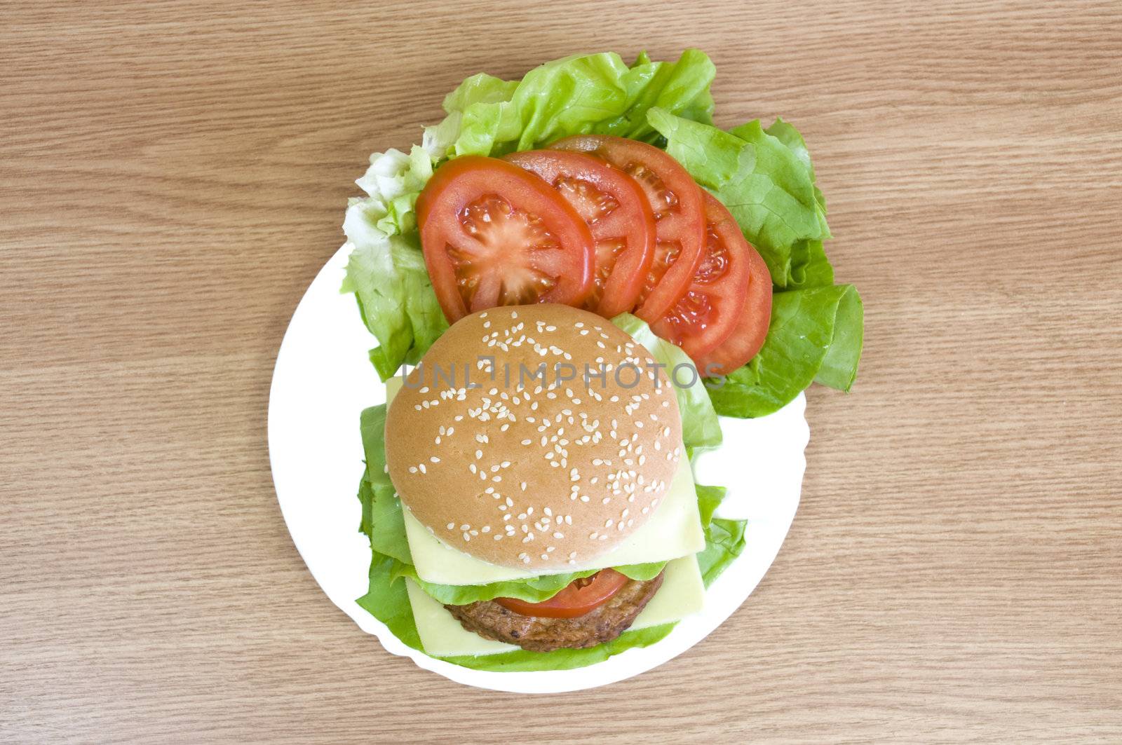 delicious beaf burger with cheese, lettuce, tomato and mayo
