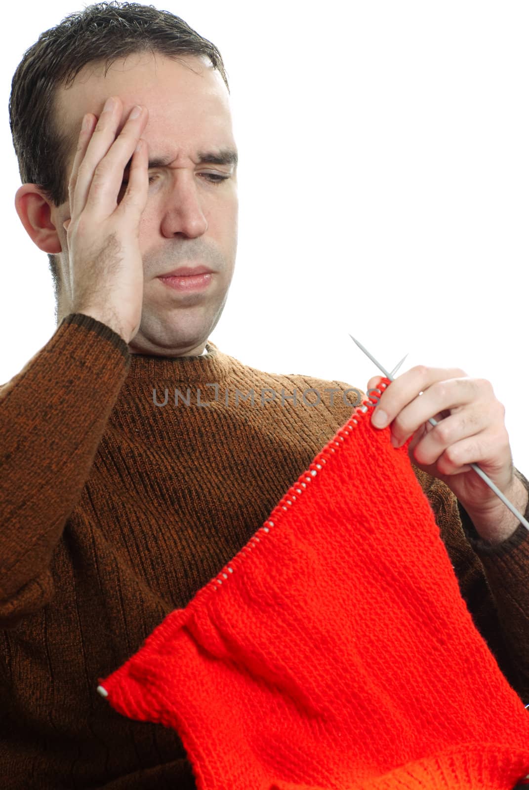 A young man is getting frustrated at his knitting, isolated against a white background