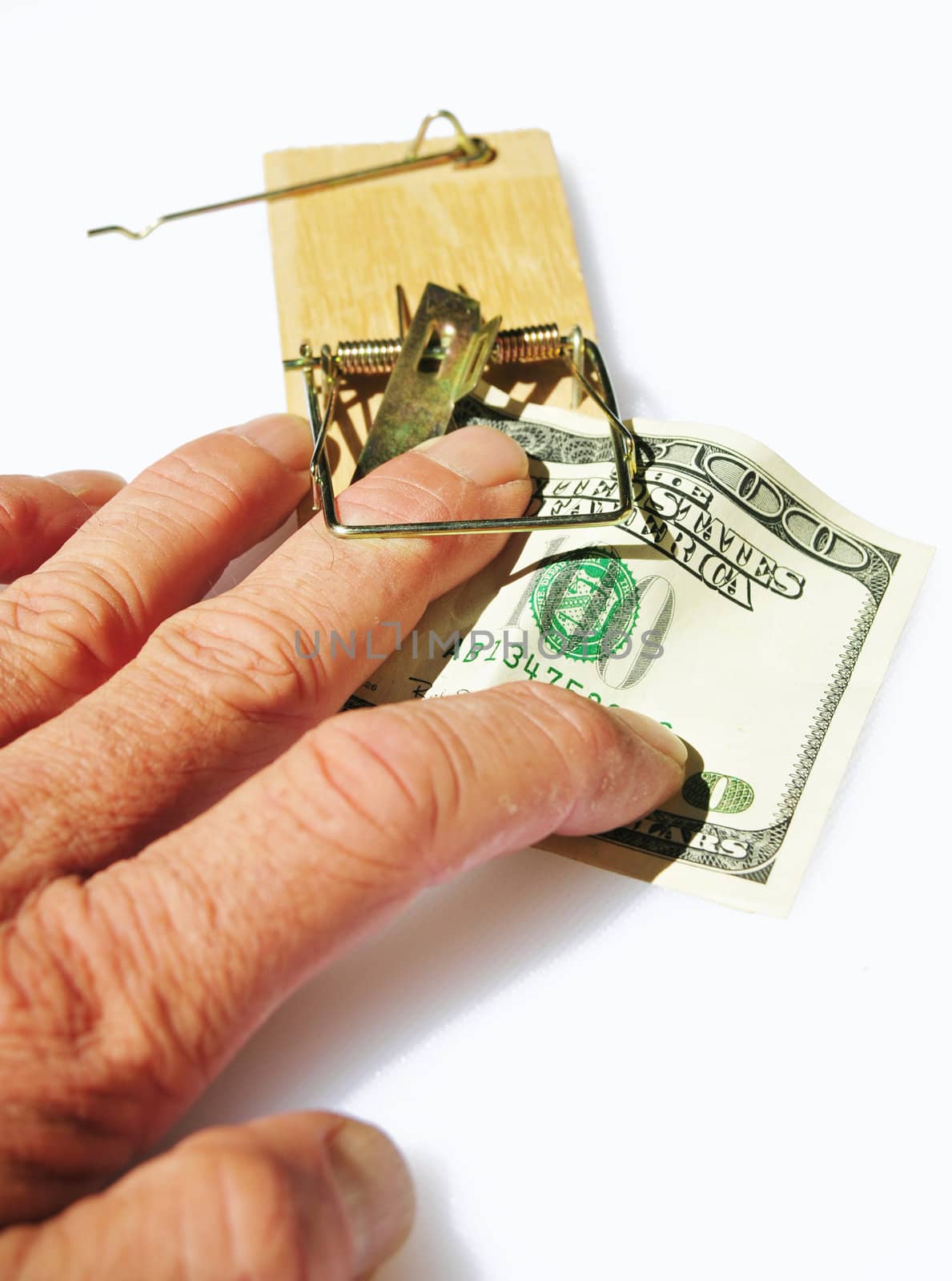 A persons fingers caught in a mousetrap when taking a hundred dollar bill used for bait.