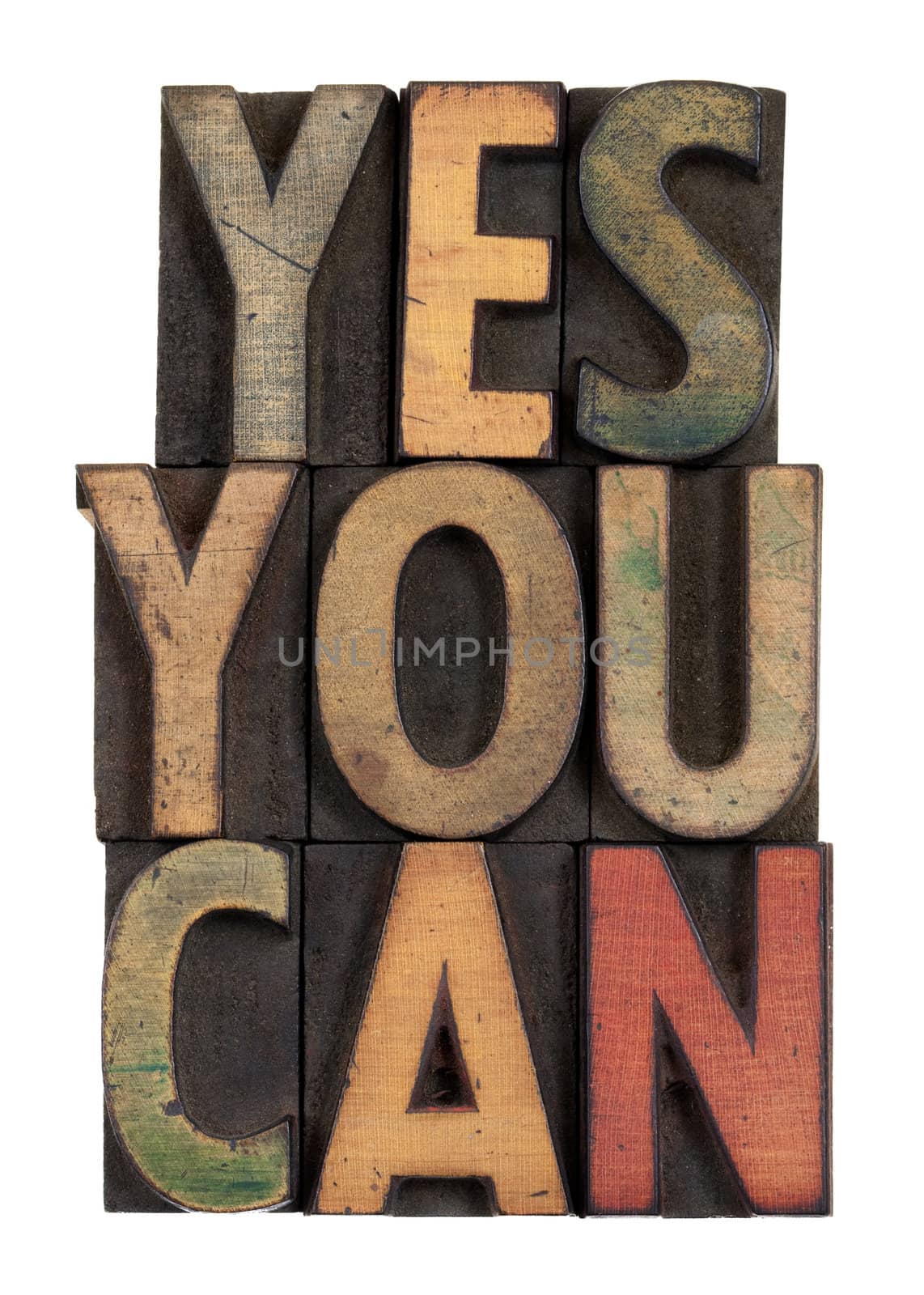 Yes you can - motivational slogan in vintage letterpress wooden type, stained by ink, isolated on white