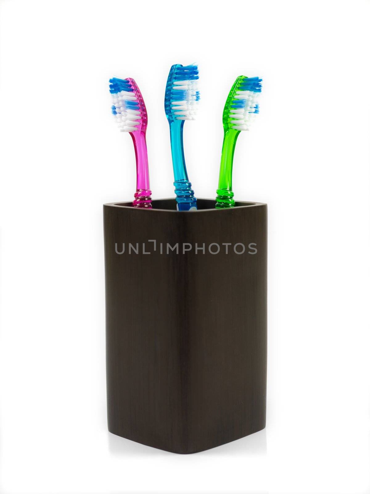 Toothbrushes in toothbrush holder isolated against a white background