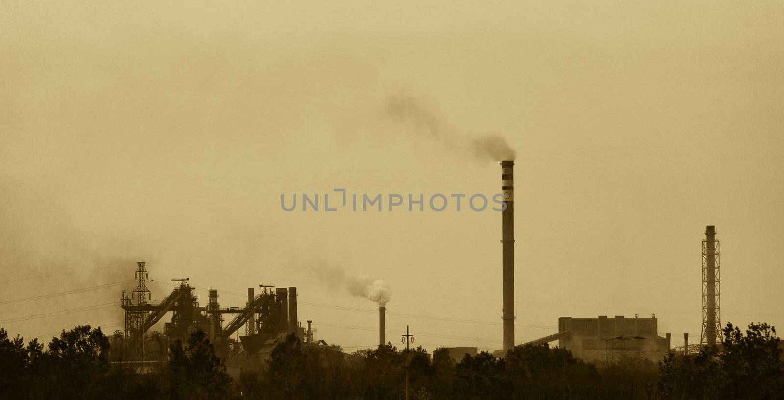 sepia toned photo of a factory polluting air