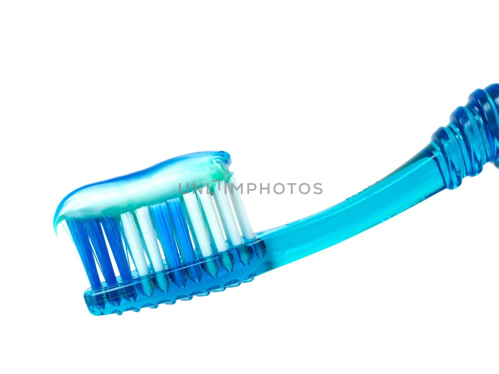 A toothbrush with toothpaste isolated against a white background