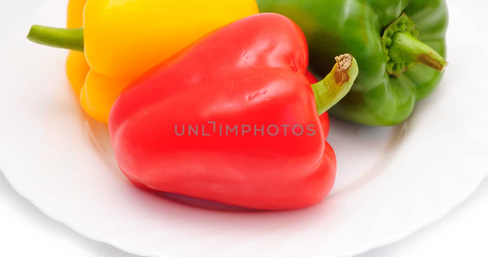 three sweet peppers (paprika) on plate