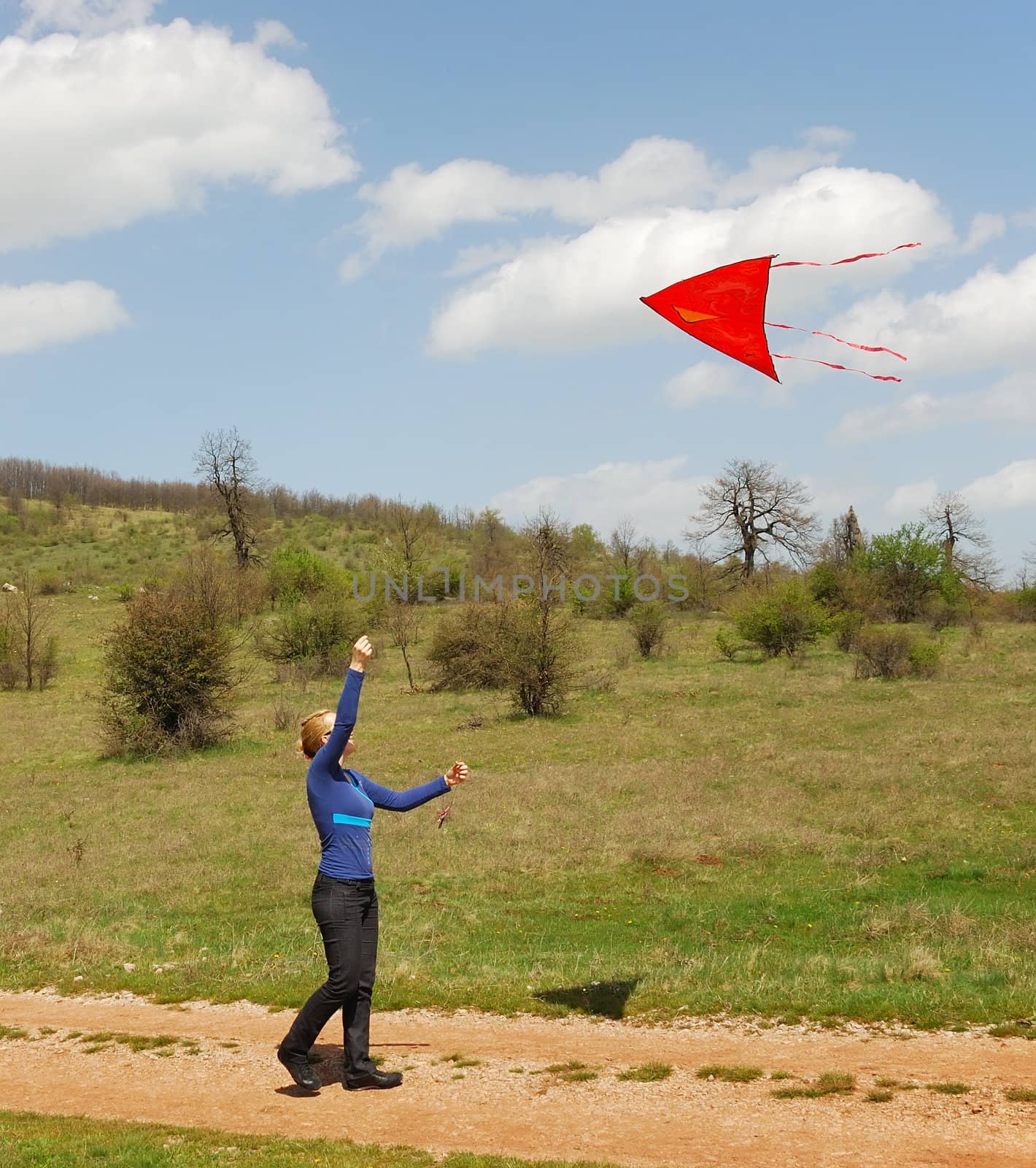a woman is playing with a kite