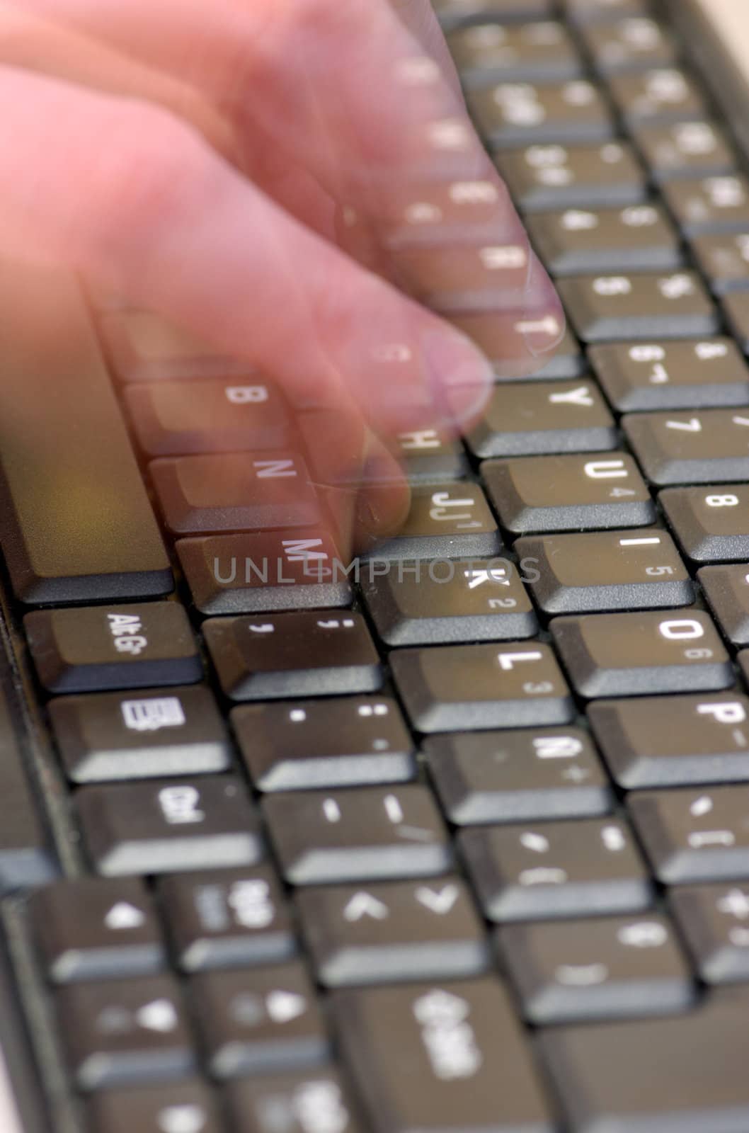 Fingers typing on a black laptop keyboard