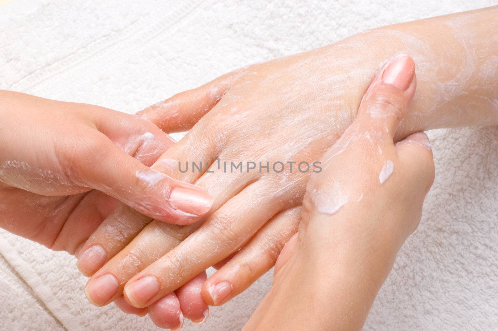 applying peeling scrub or moisturizing cream onto the hands