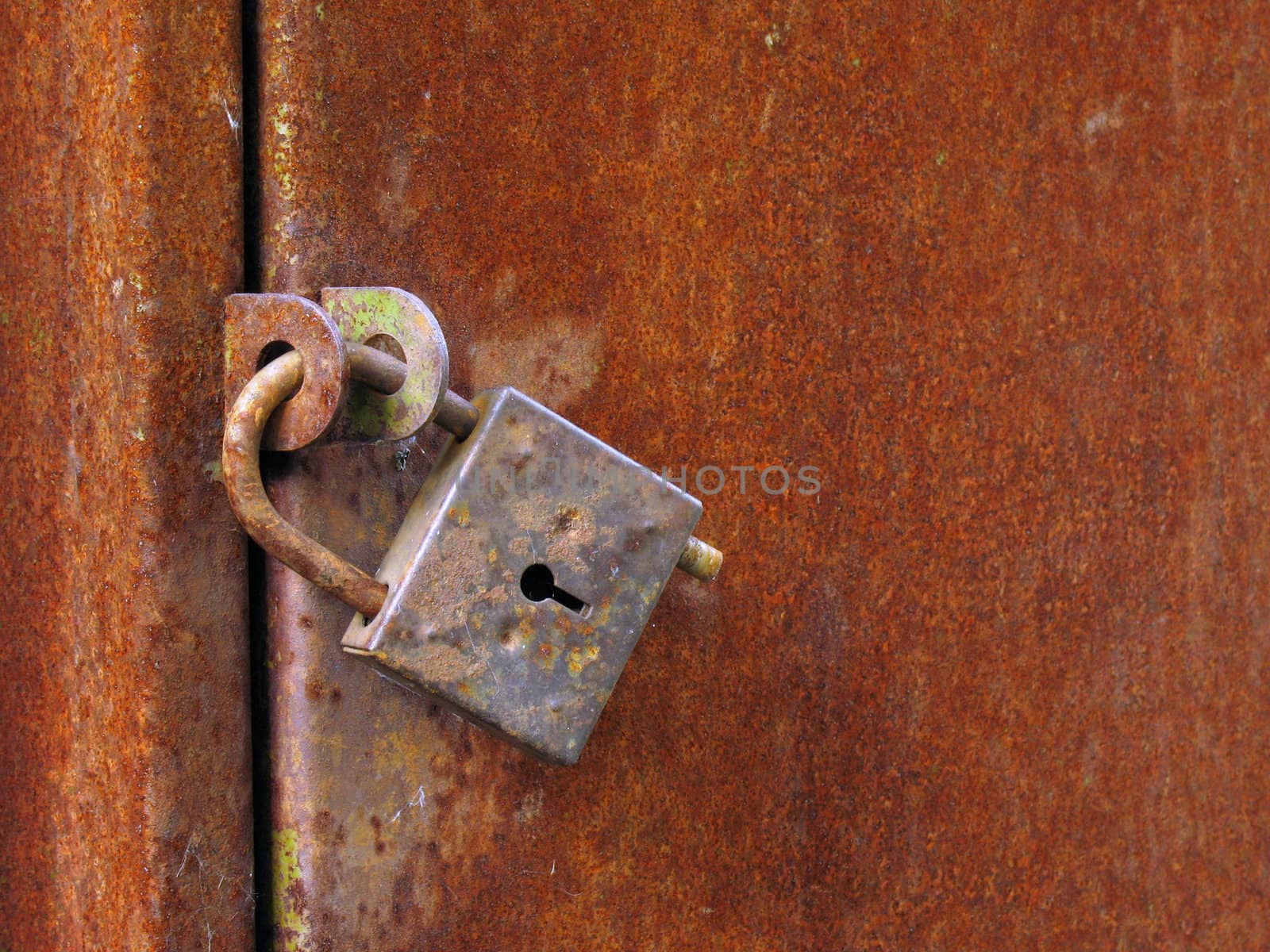 Old closed padlock by Vitamin