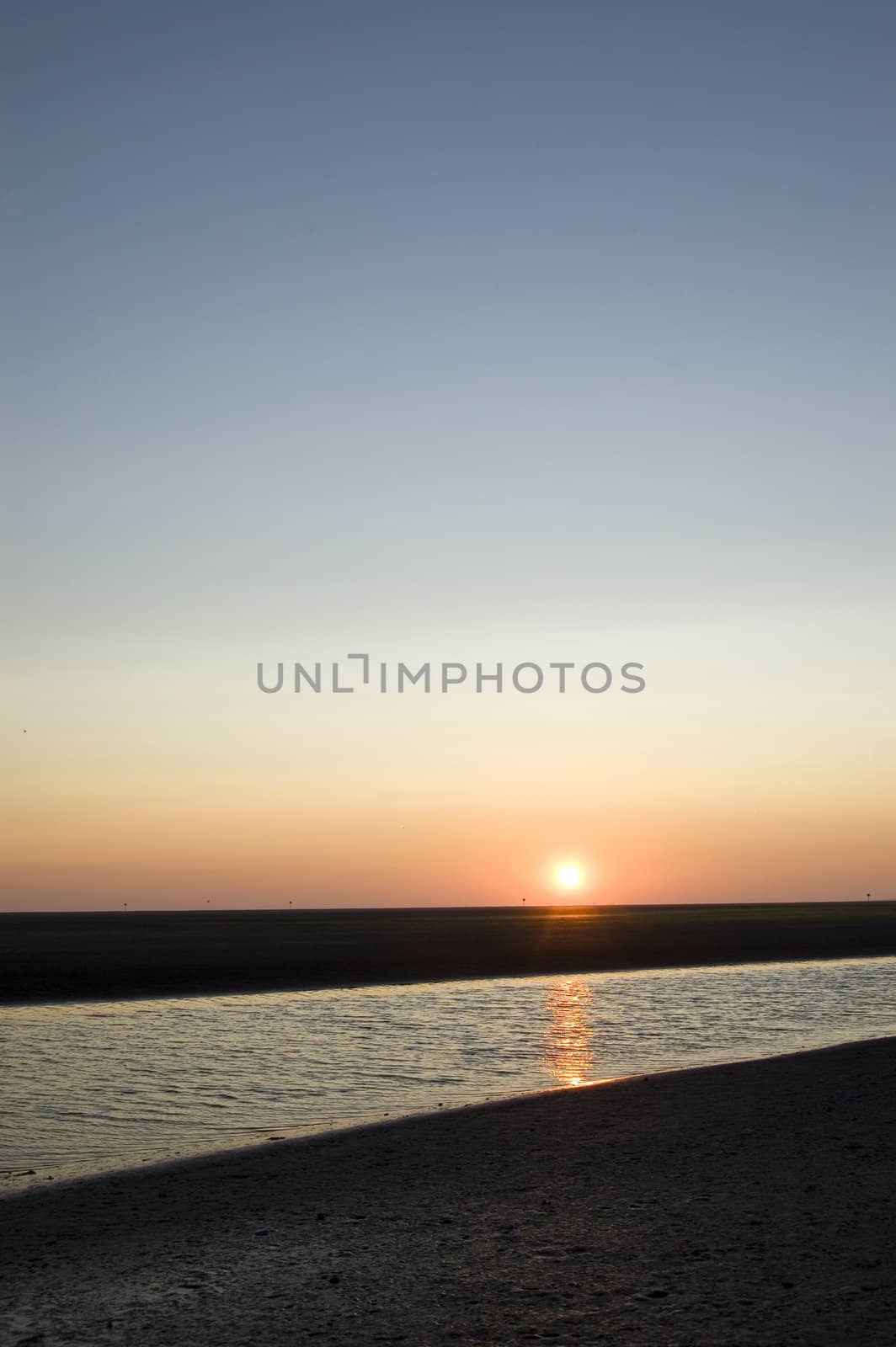 sunrise on the beach on ameland; the netherlands