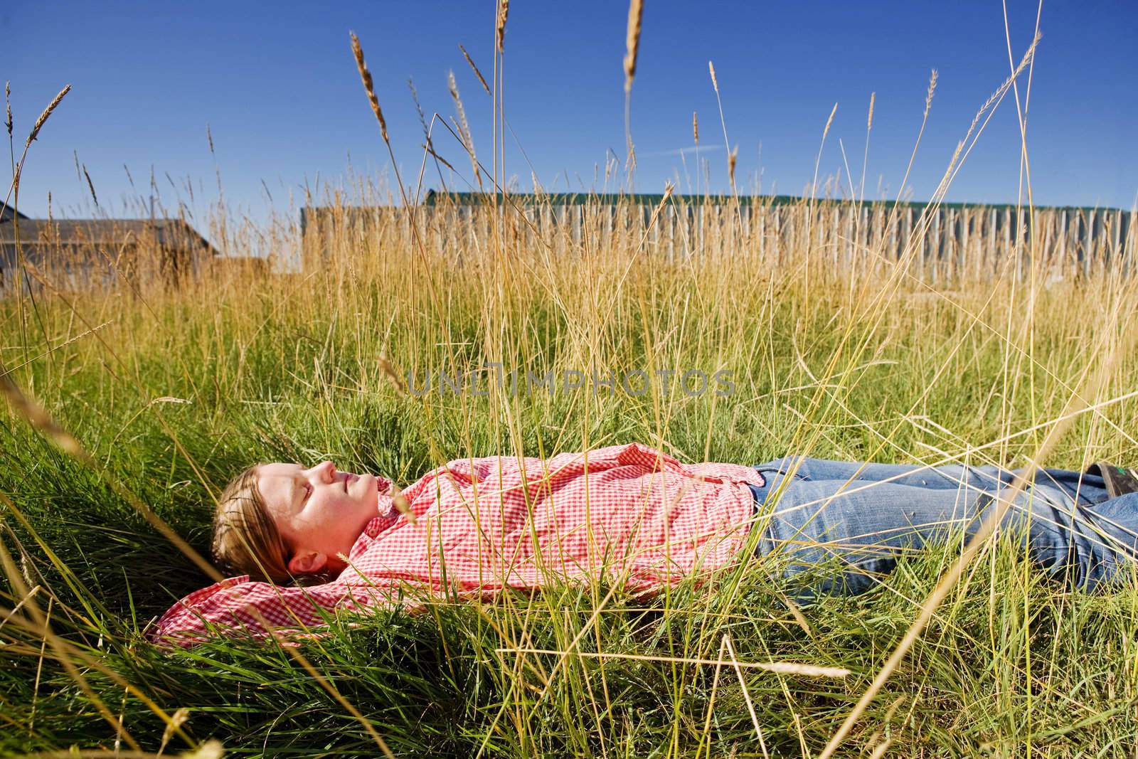 A farm girl relaxing in the grass