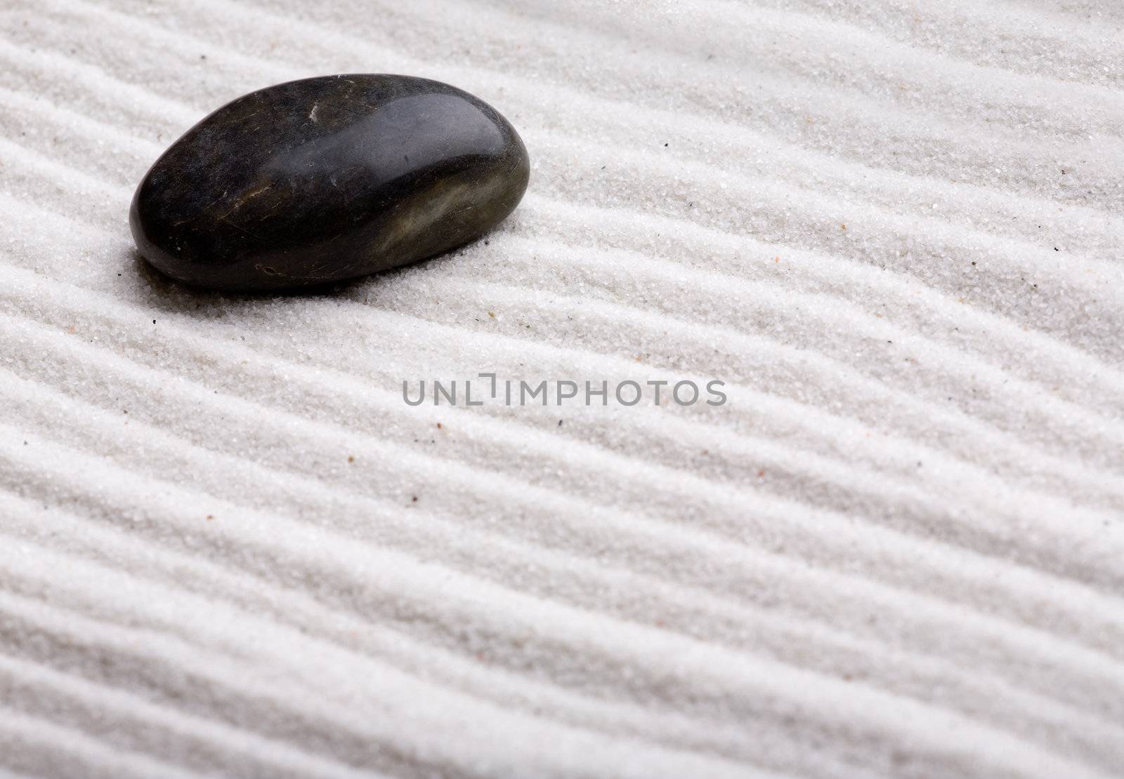 A rock in beautifully styled white sand