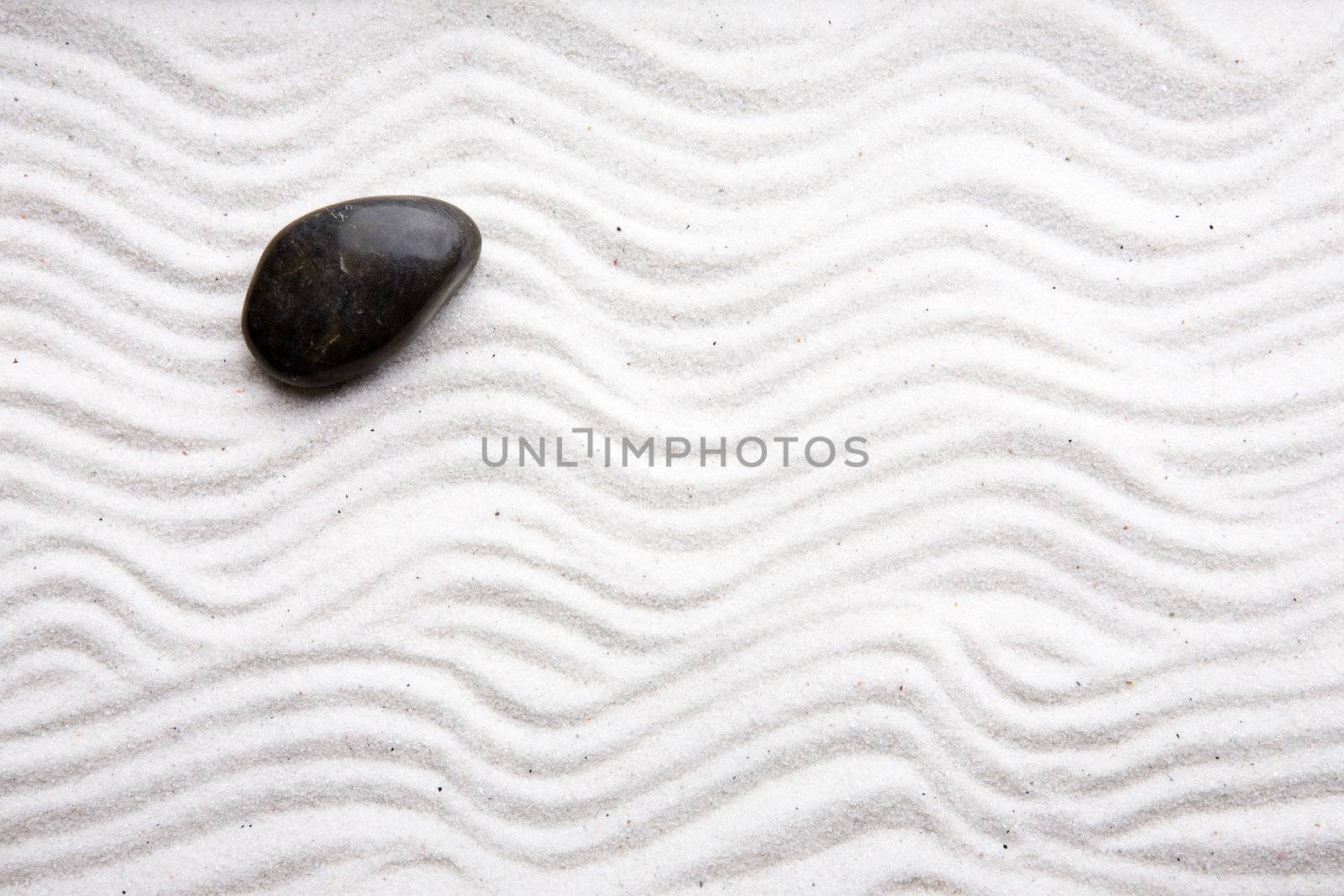 Japanese zen rock garden with white raked sand