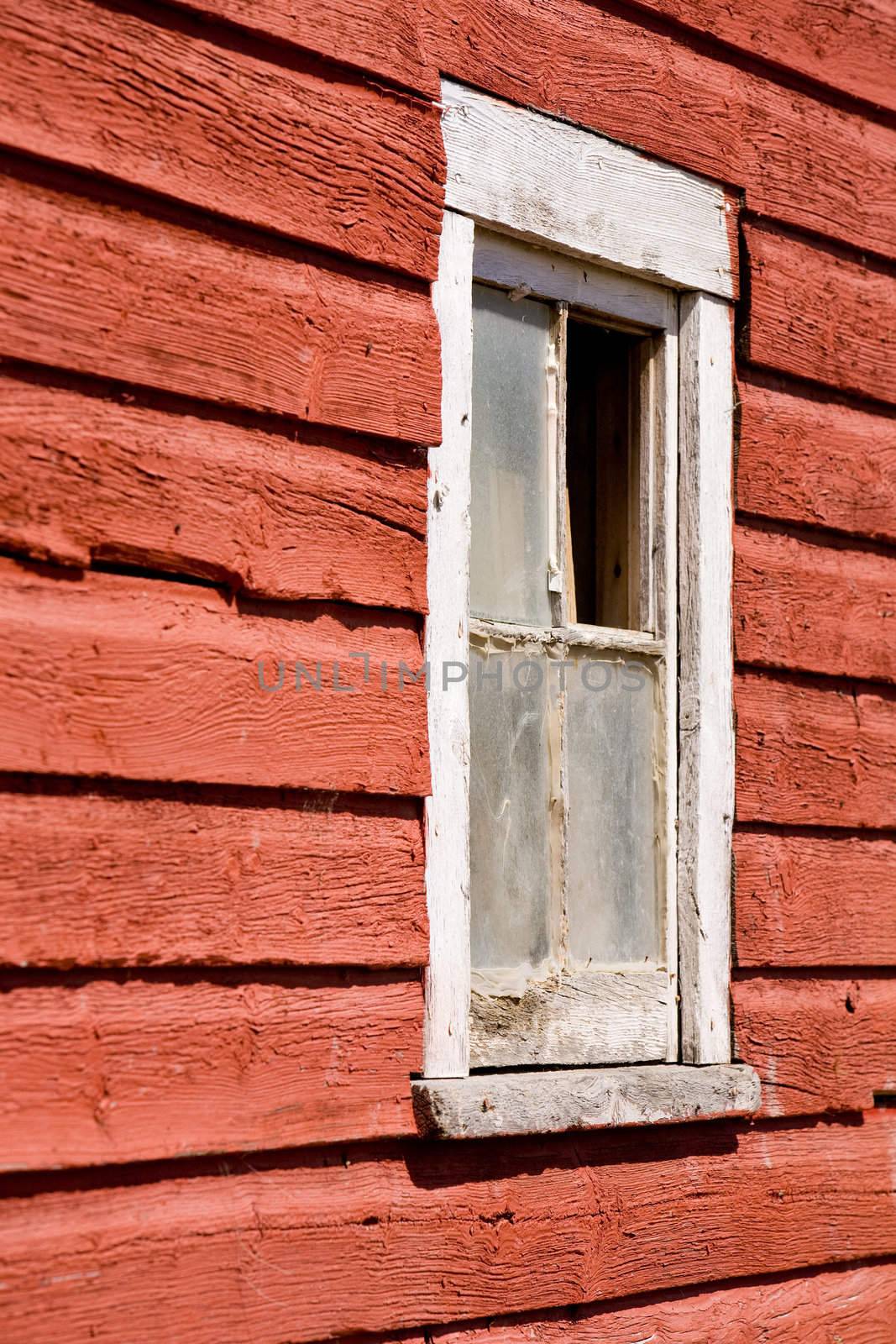 An old red barn window