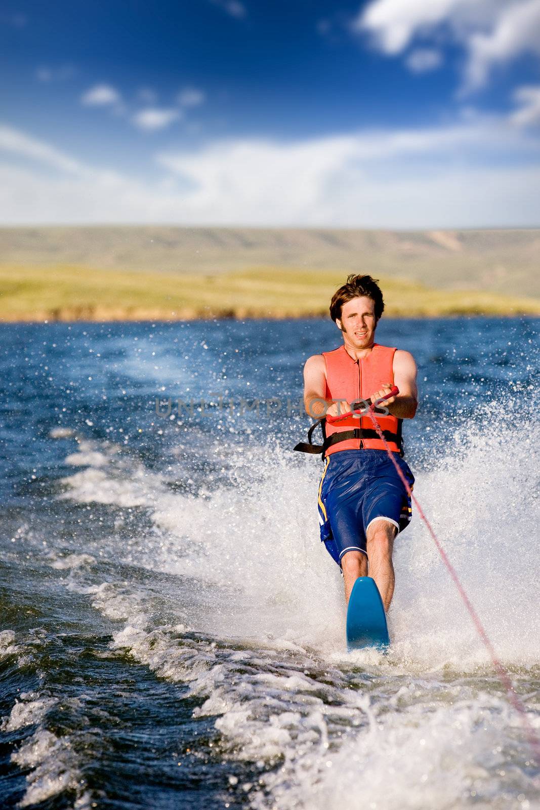 A man water skiing on a lake