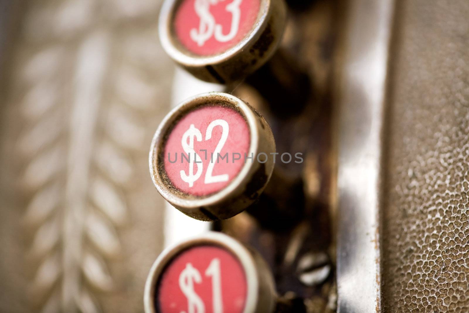 A 2 dollar button on a retro dirty cash register - shallow depth of field
