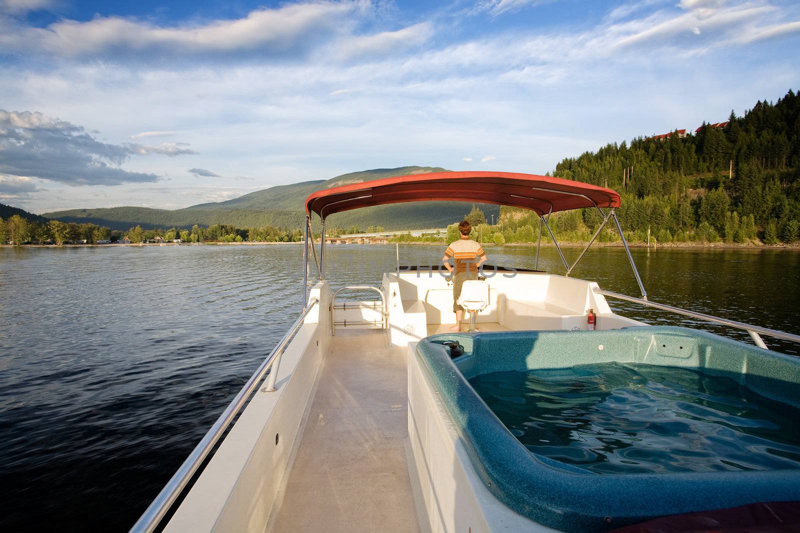 A hot tub on a luxury boat on a lake at sundown