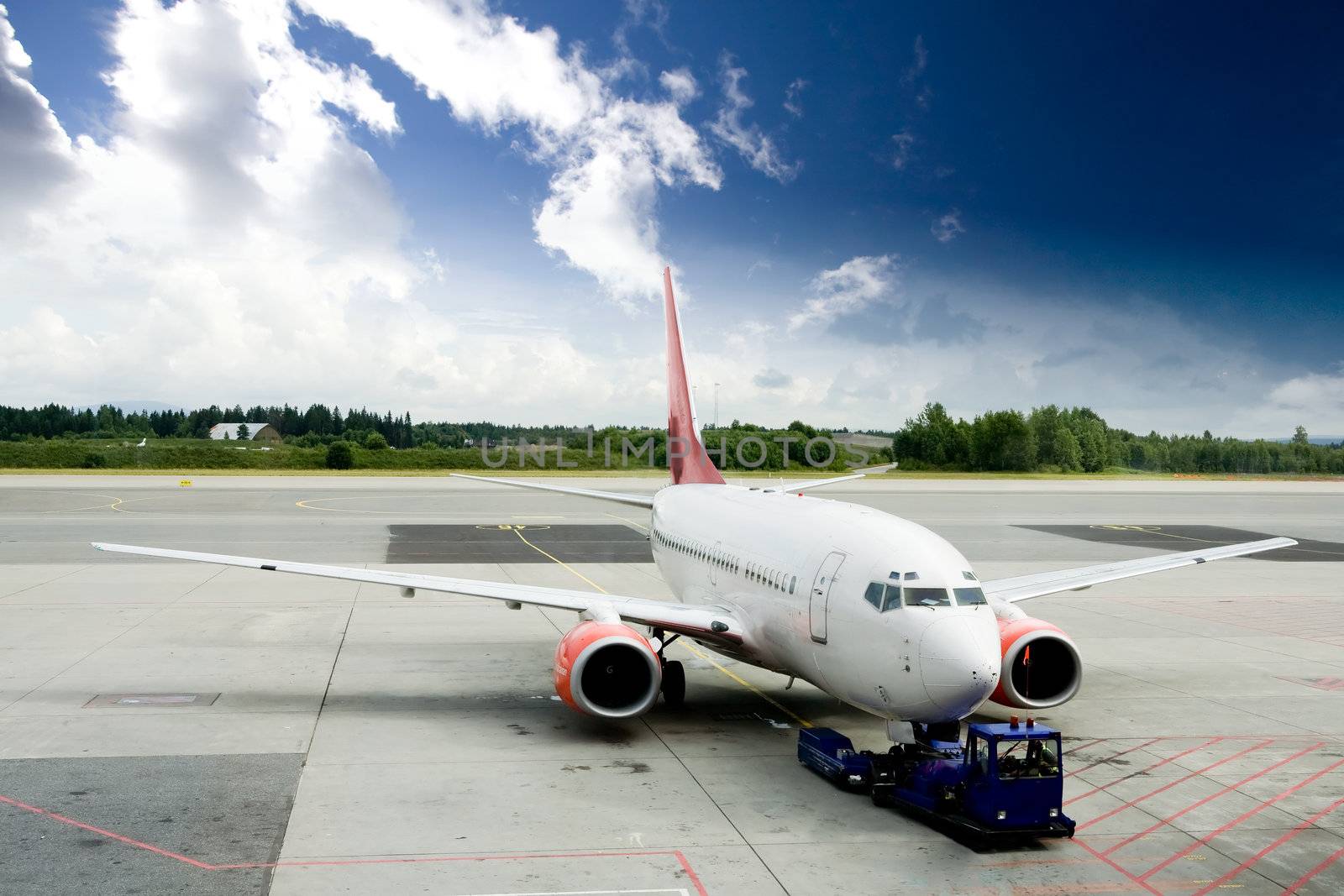 An airplane at the airport on the tarmac