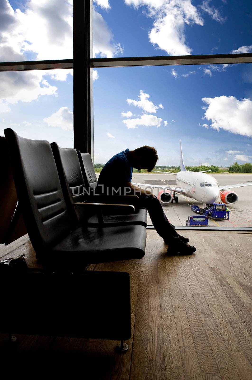 A male waiting sleeping in the airport