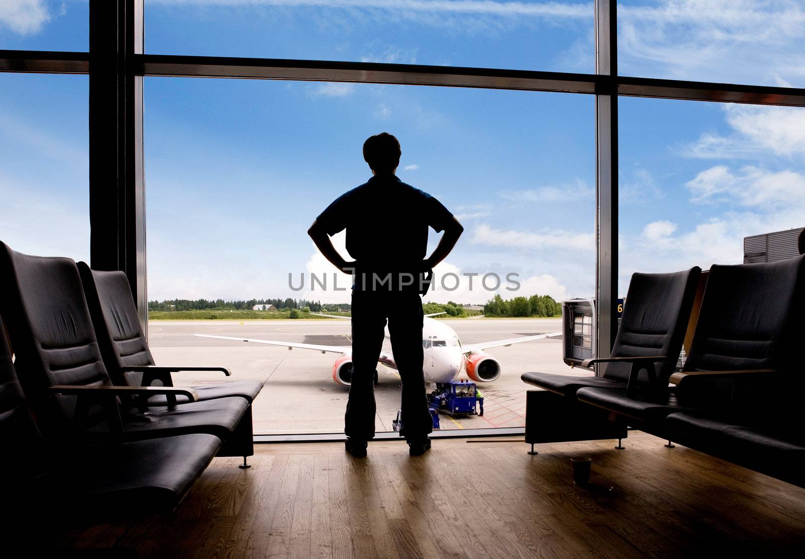 A male waits in a terminal at an airport