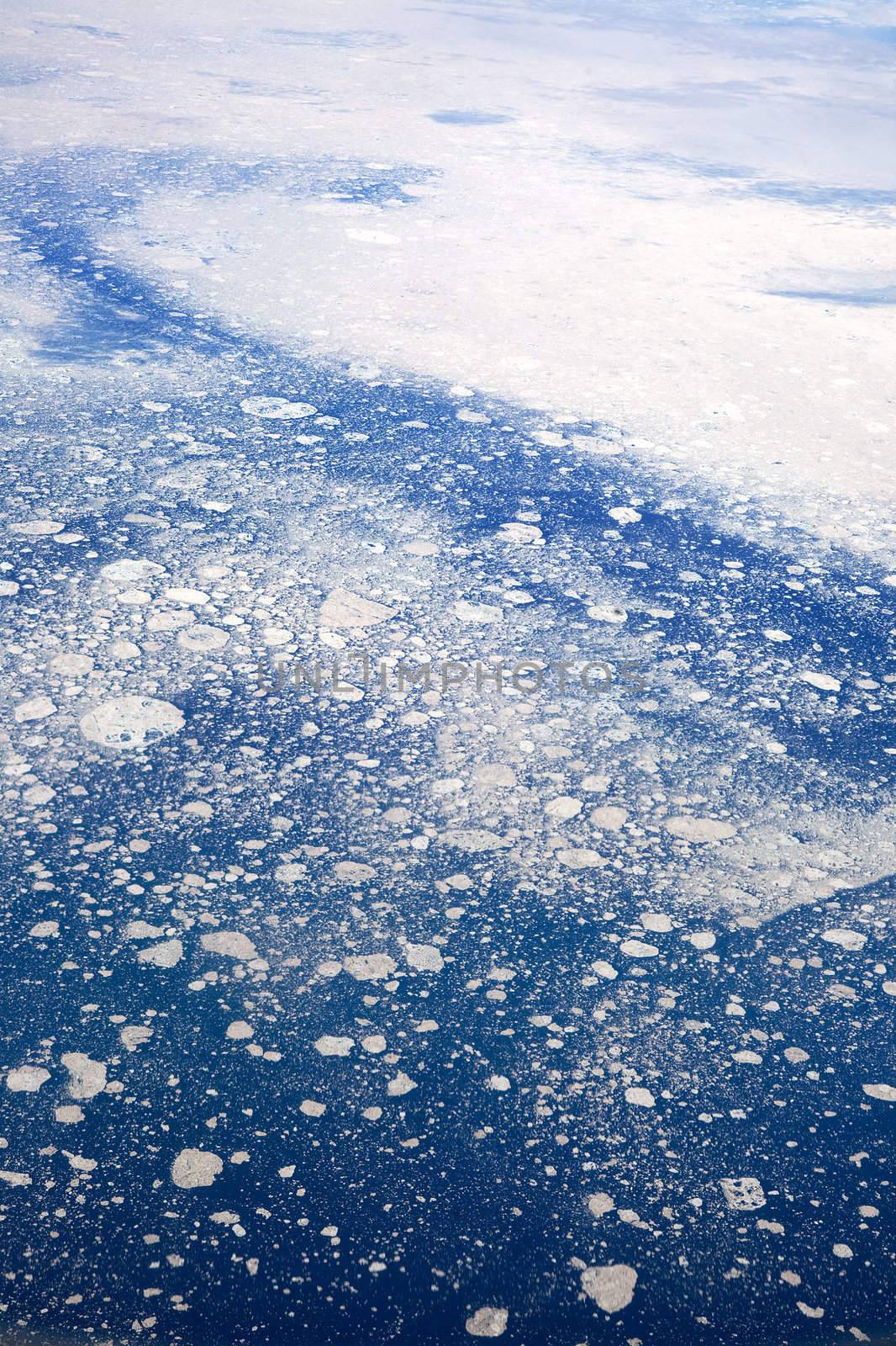 An aerial view of a melting glacier in the ocean.