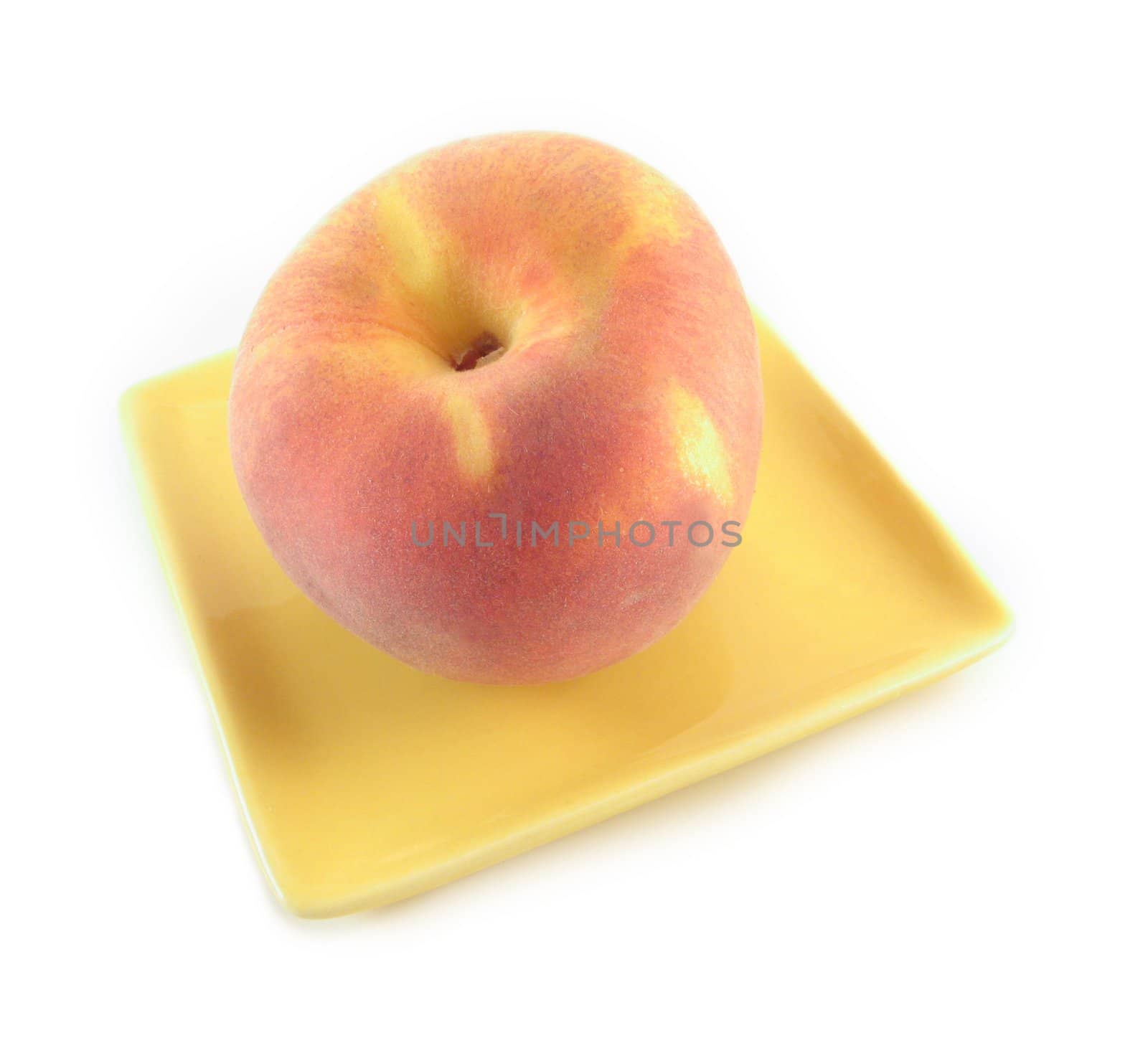 image of a peach on a yellow plate