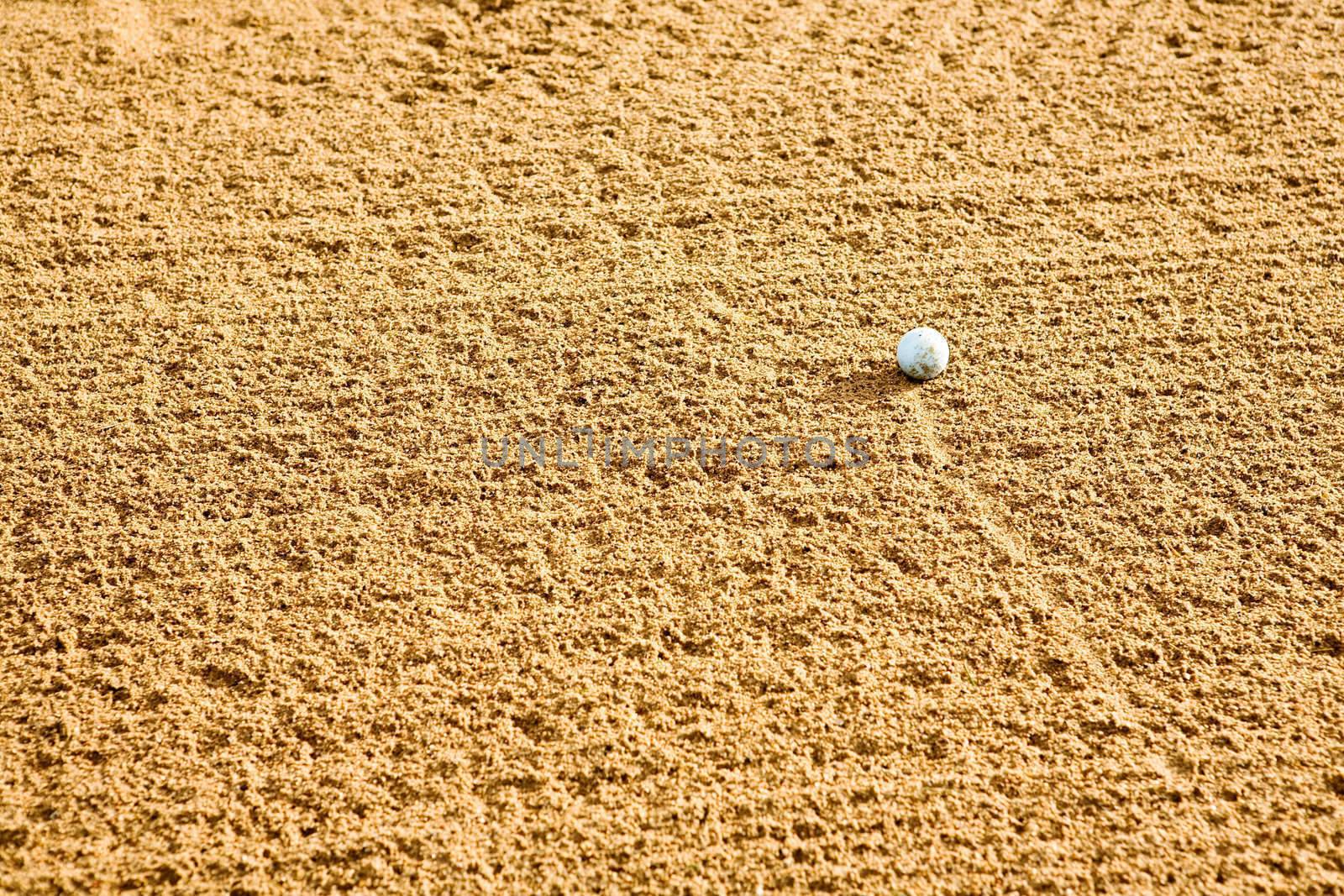 A golf ball in a sand trap