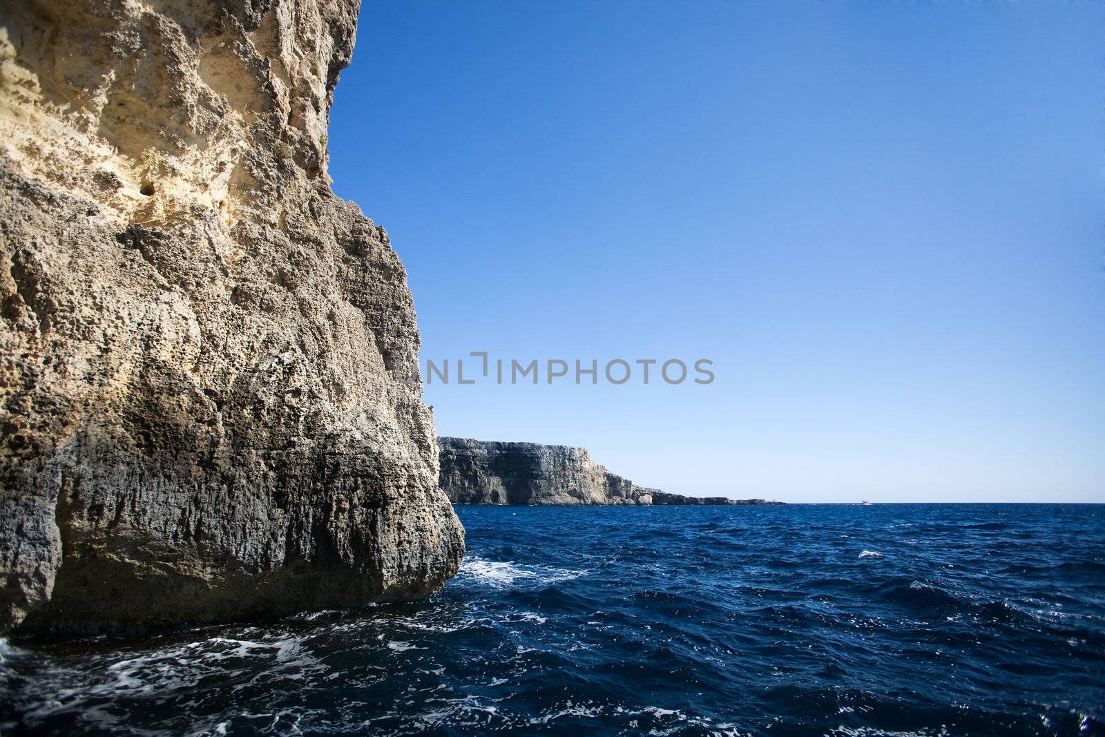 A cave in the ocean with a ciff opening