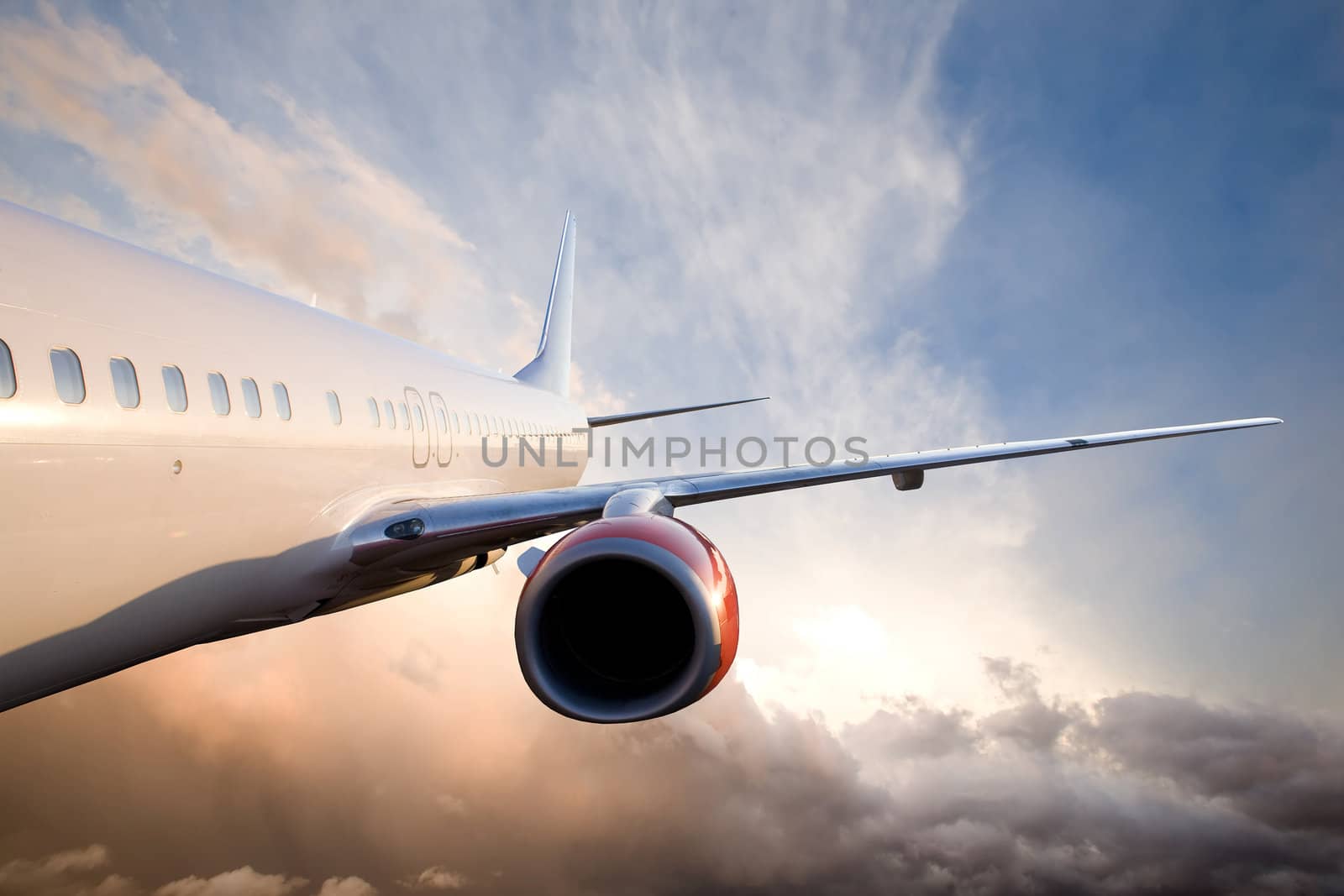 An airplane flying over a dramatic sky