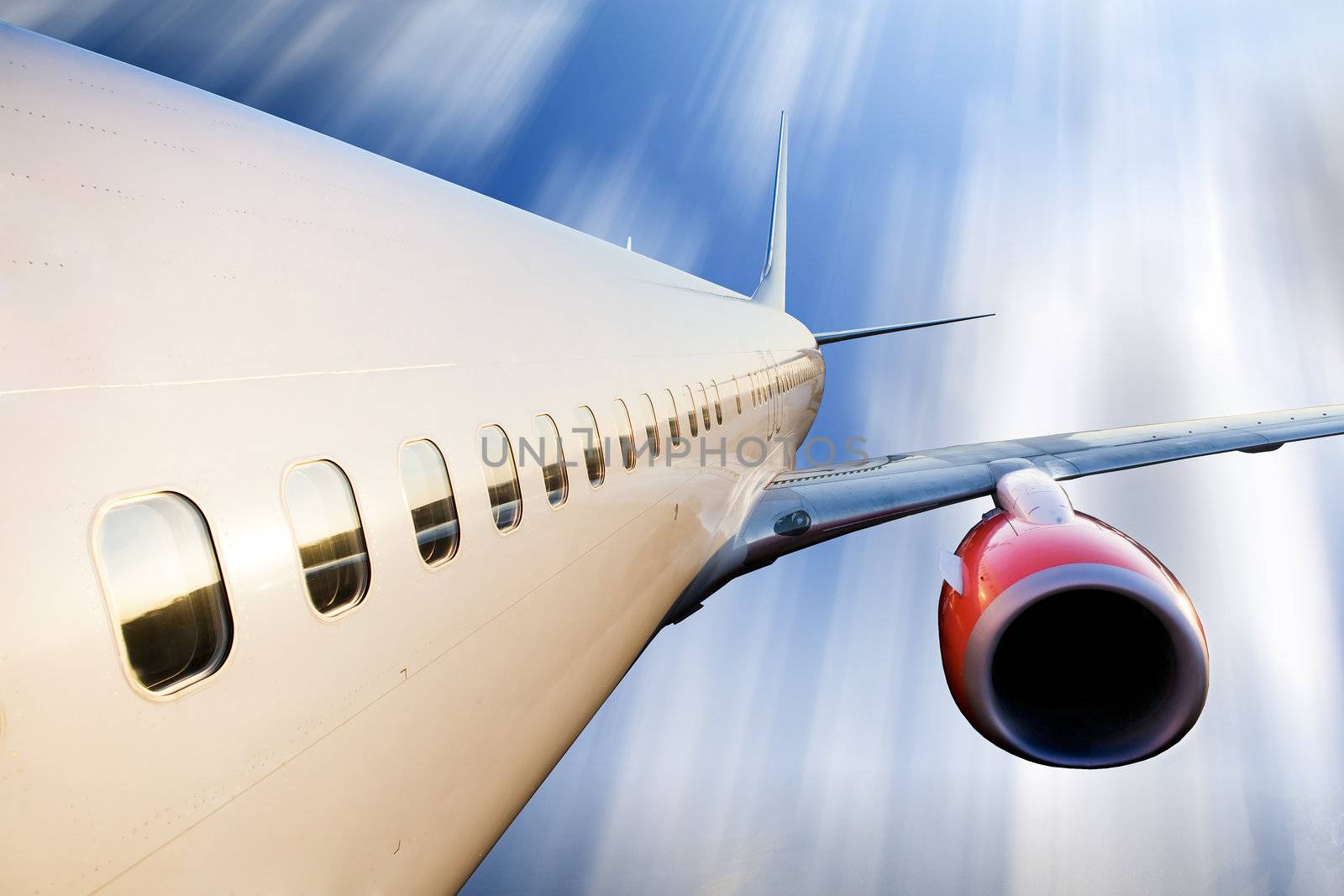 An airplane in flight over a blue sky