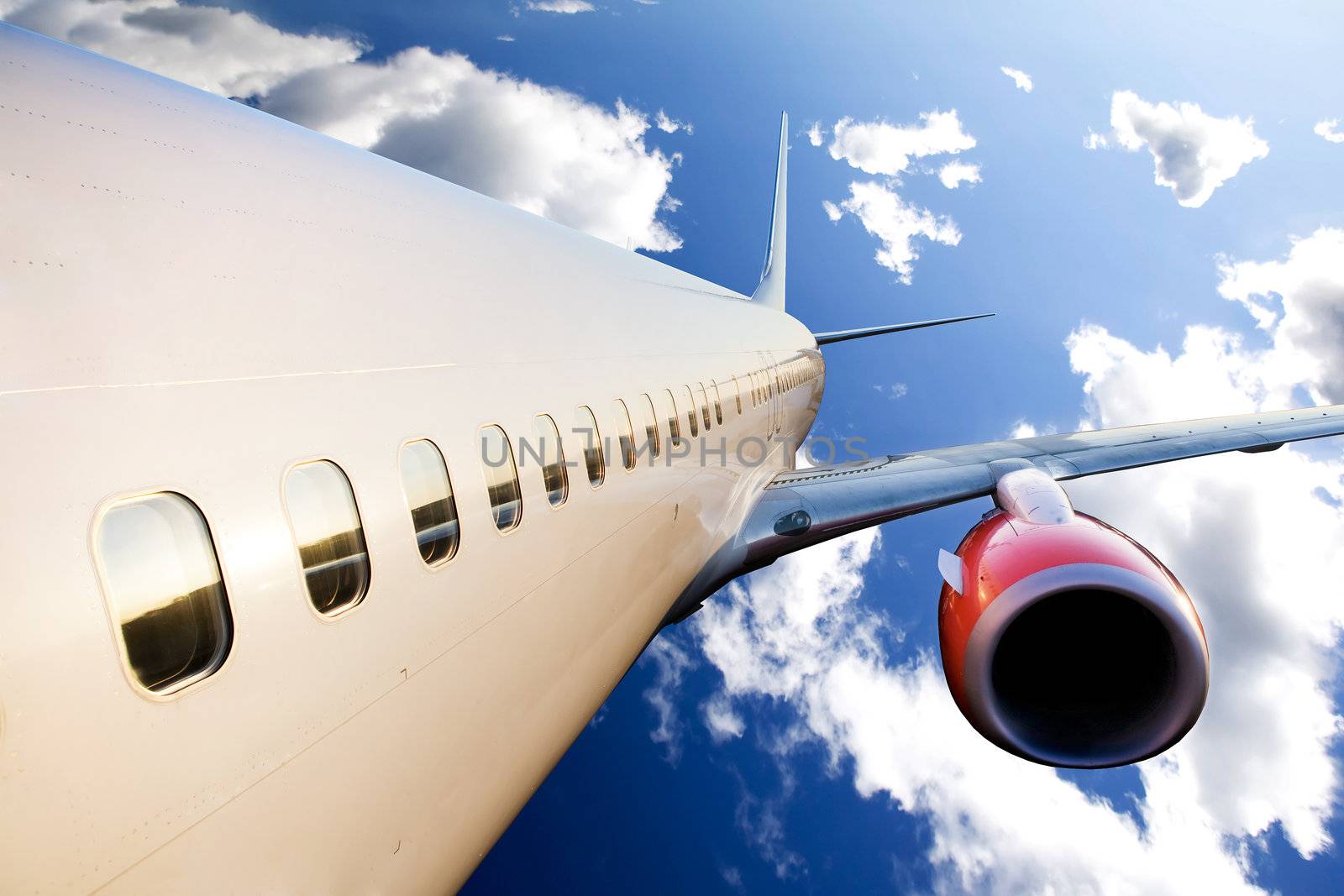 An airplane in flight over a blue sky