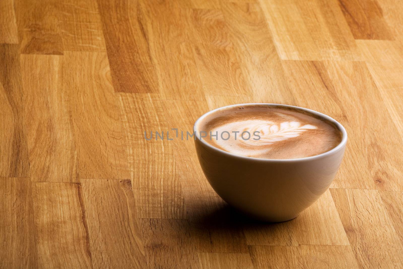 Cafe latte on a wood table with copy space