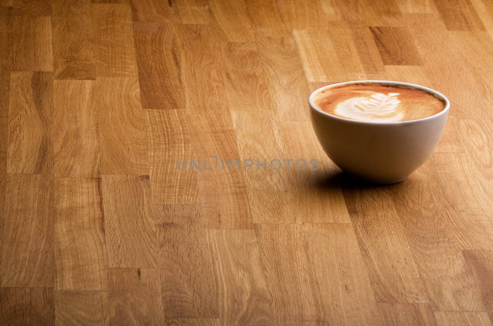A warm specialty coffe on a wood table