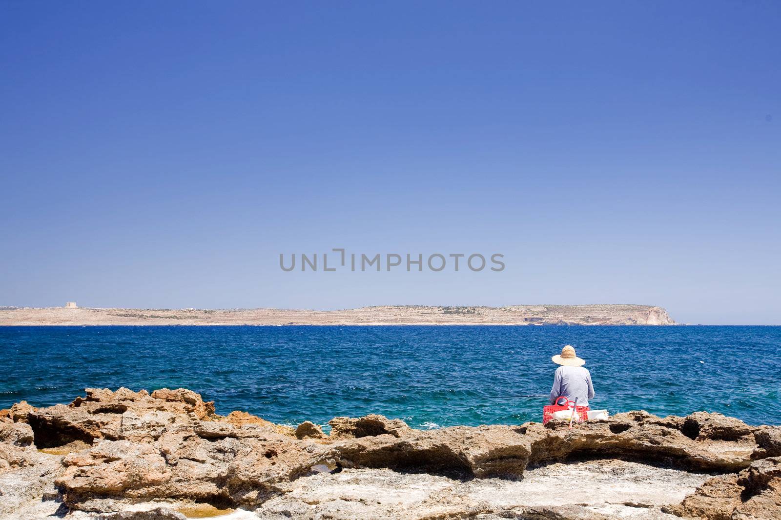 A maltese fisherman fishing in the sea