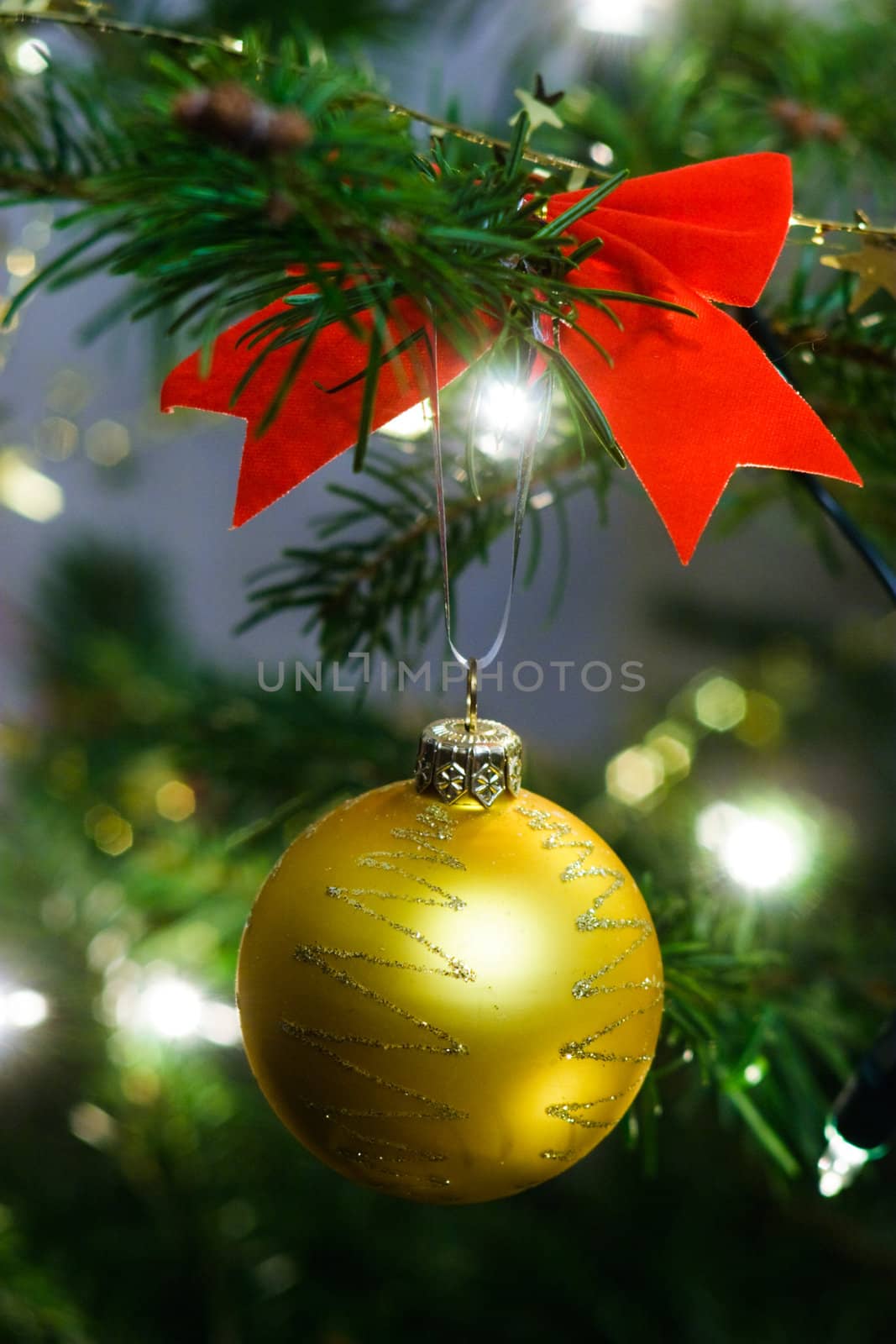 Yellow christmas ball on the fir tree