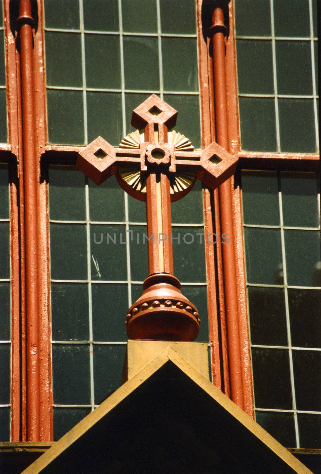 Detail of church front window with ornate cross