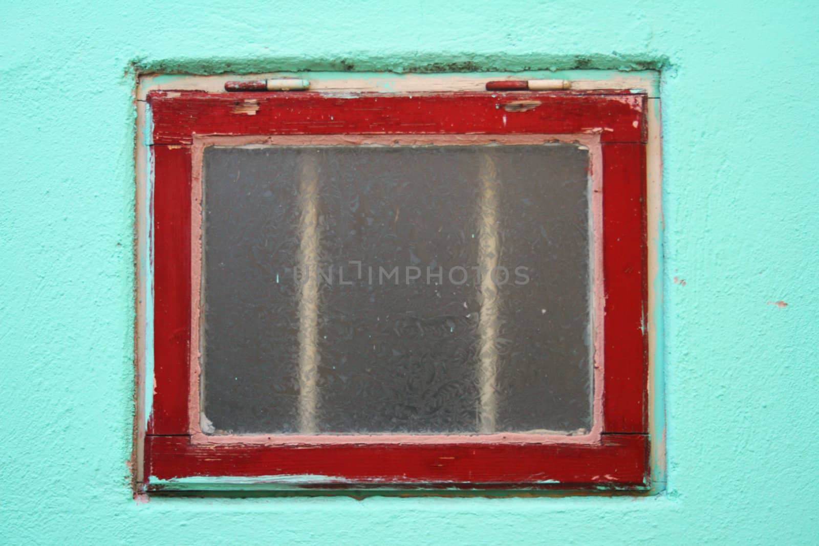 Red window against turquoise wall