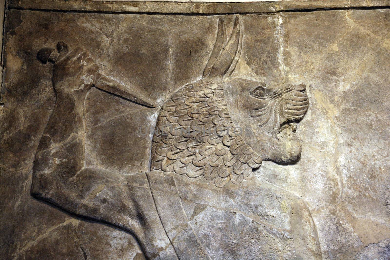 relief of an assyrian god with cougar head