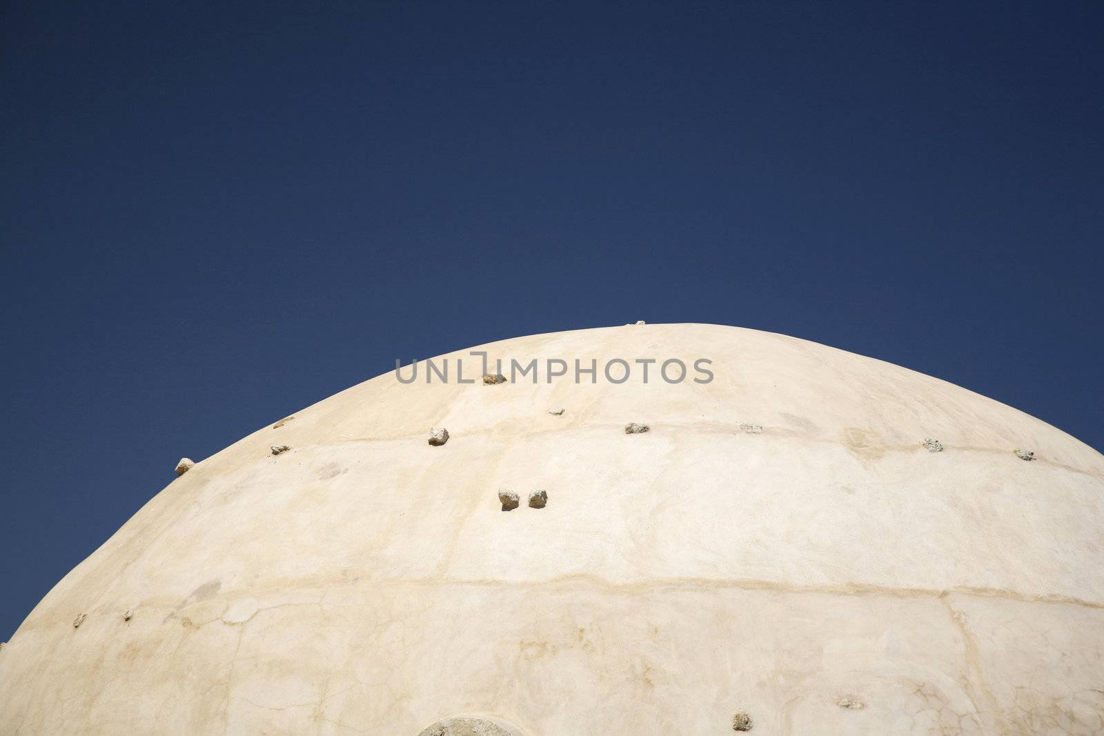 pale cupola with stones and a dark blue sky
