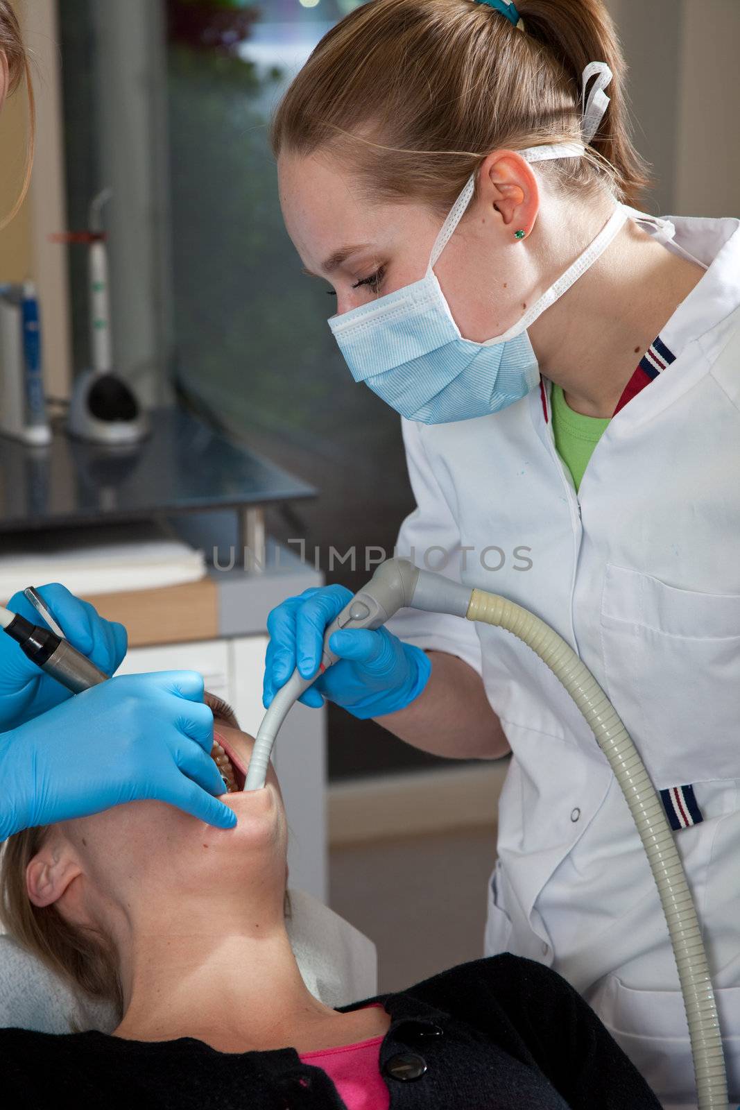 female dental assistant working on a patient